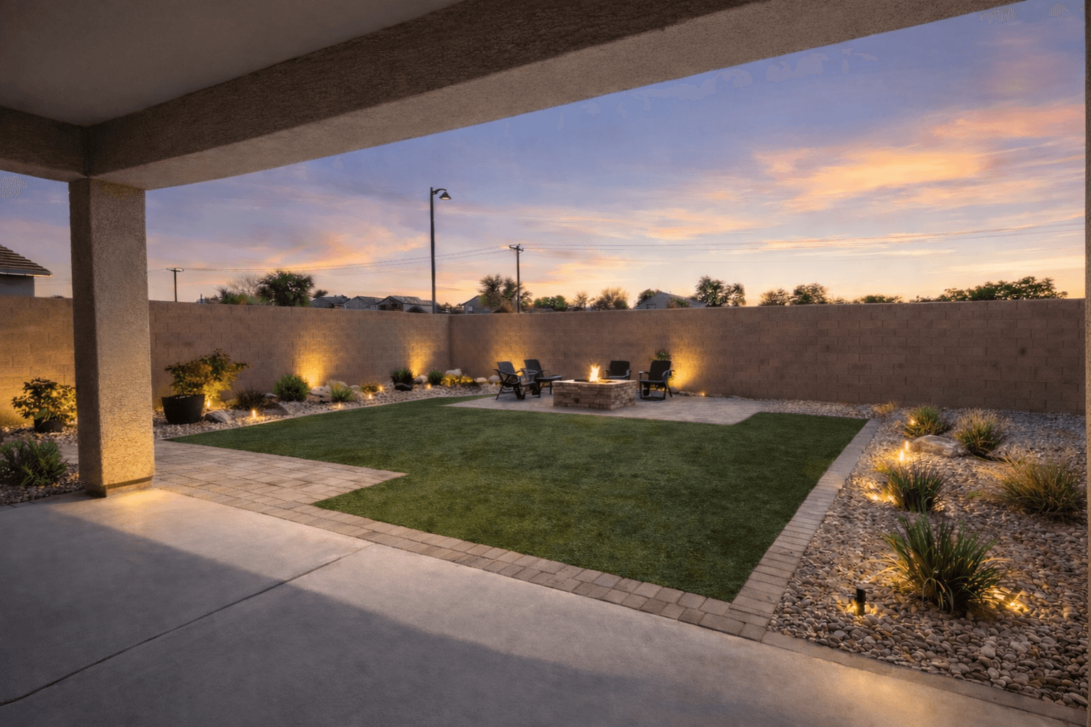 Backyard with turf and pavers at sunset — Arizona