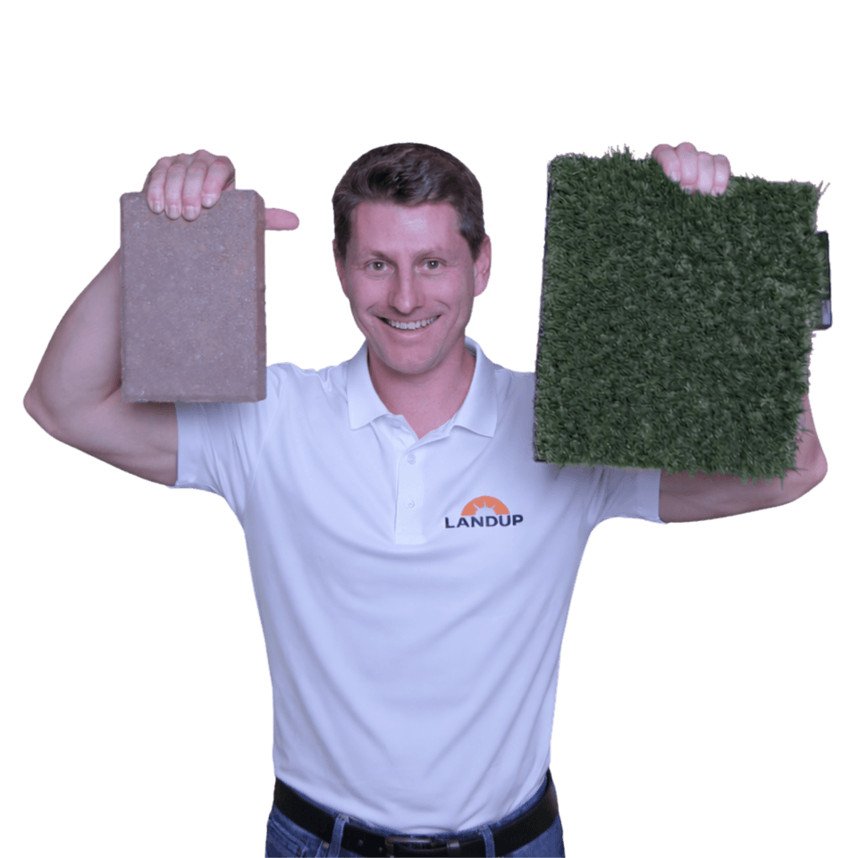 LandUp installer holding pavers and turf samples